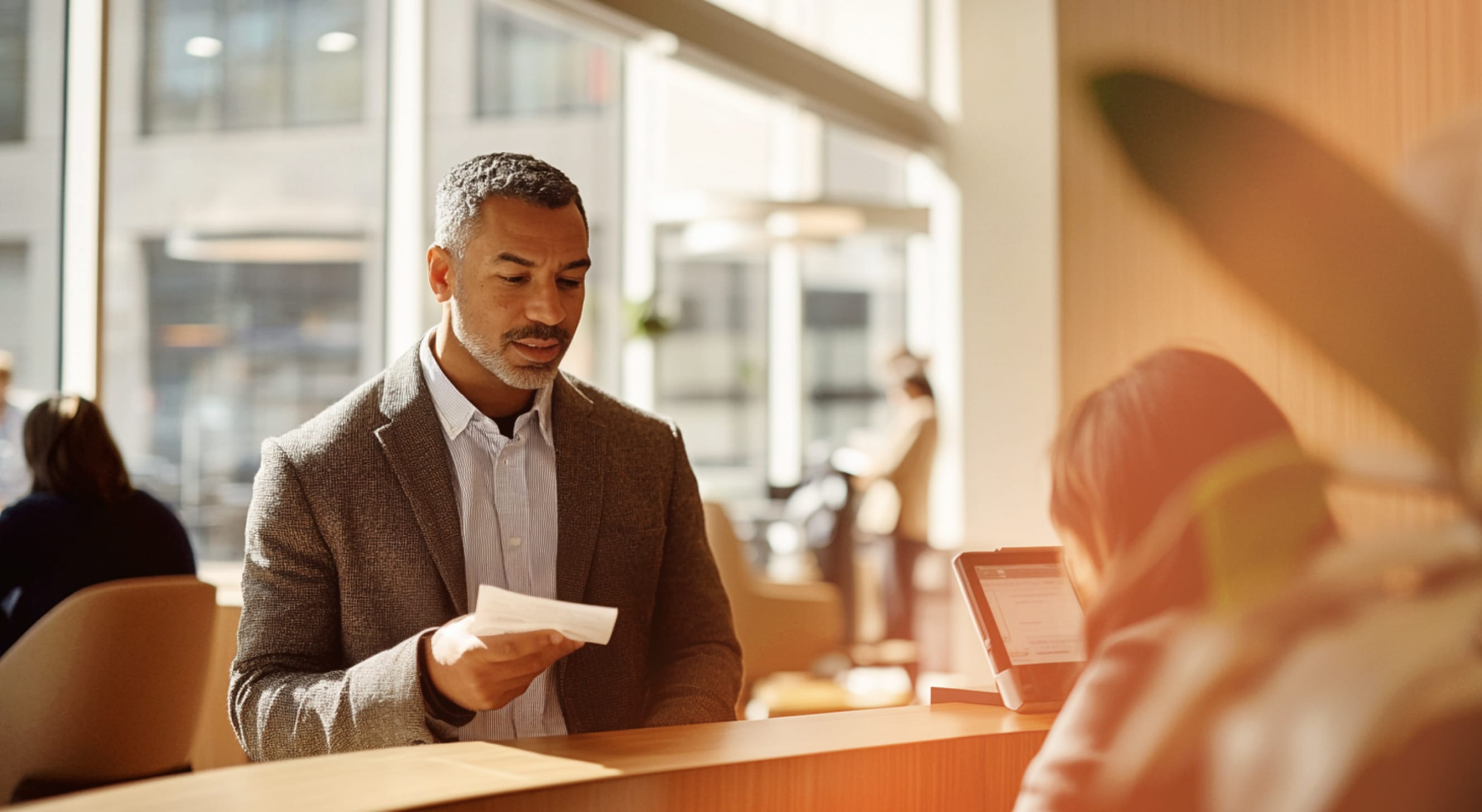 A male customer talking to a female receptionist