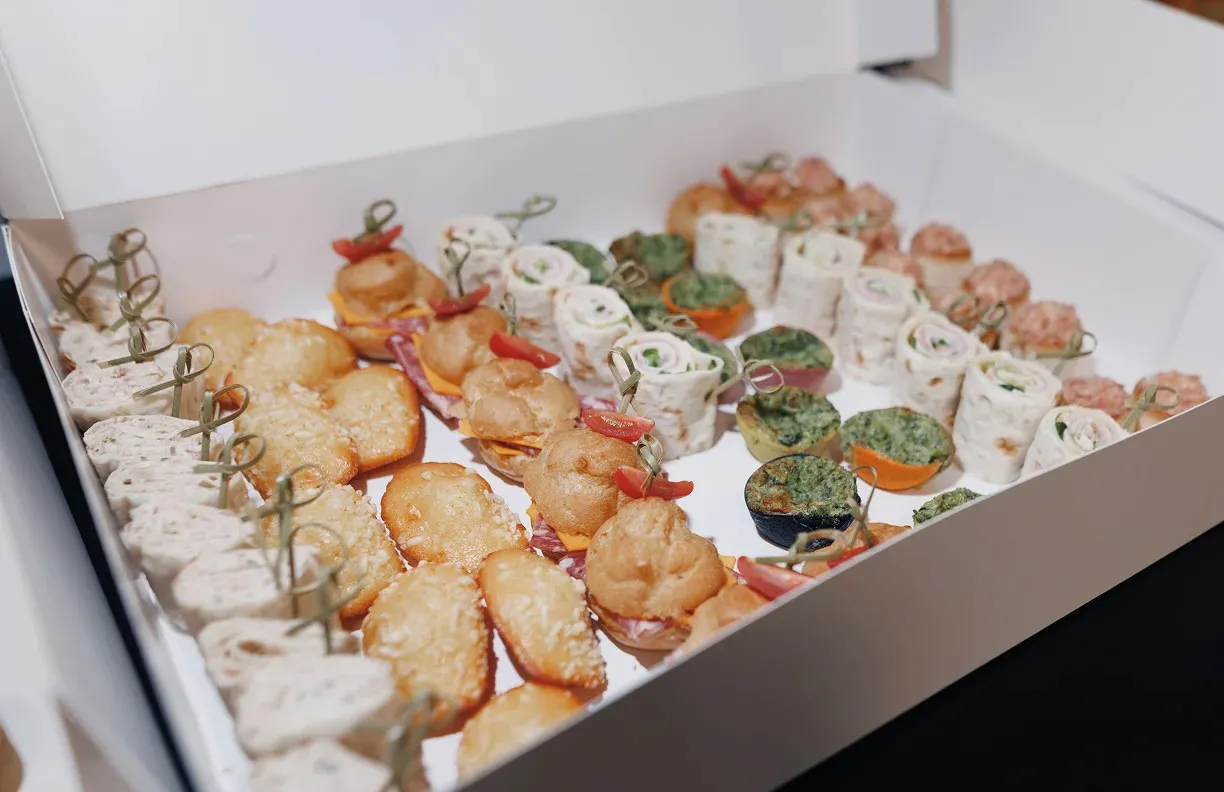 A platter of bread, cheese, meat, and spread