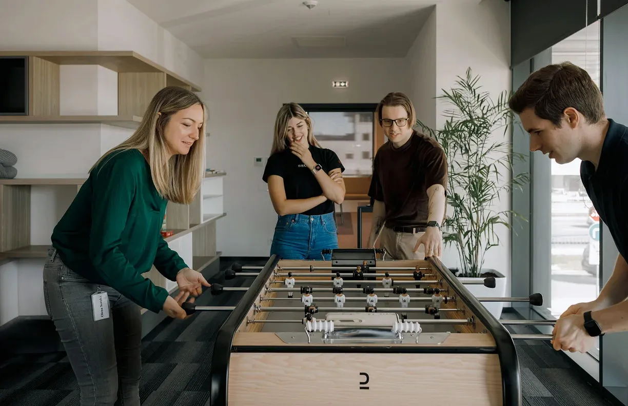 A couple of office colleagues playing foosball