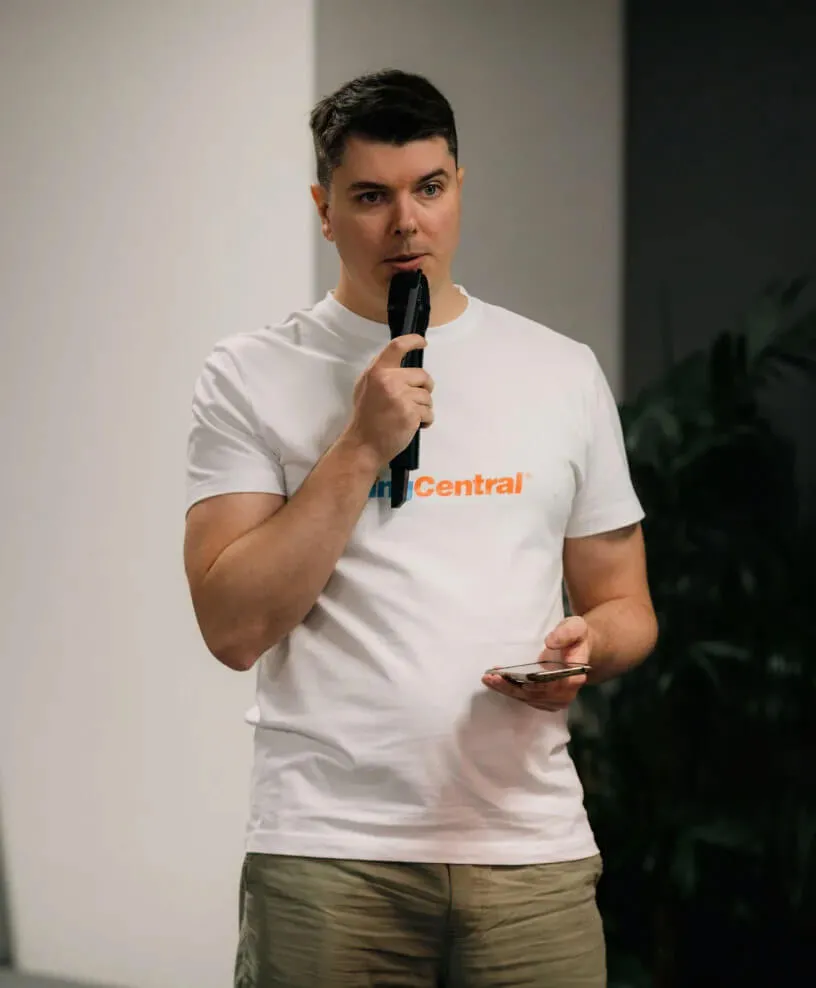 A man wearing a RingCentral shirt speaking on a mic
