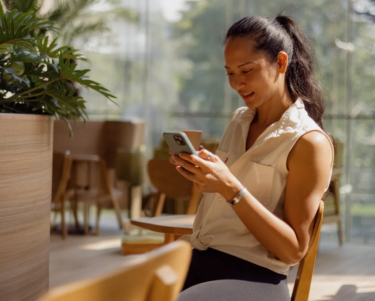 A woman using her mobile phone to check messages about her virtual fundraising campaign