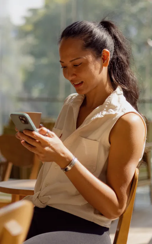 A woman using her mobile phone to check messages about her virtual fundraising campaign