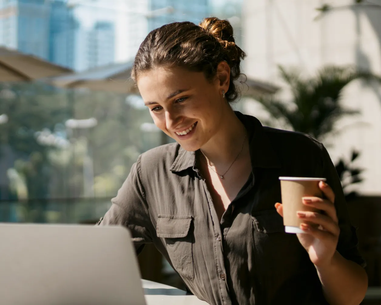 A woman using her laptop to work remotely and join donor meetings online