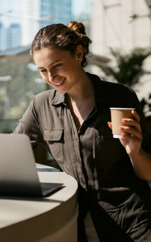 A woman using her laptop to work remotely and join donor meetings online