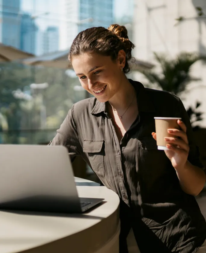 A woman using her laptop to work remotely and join donor meetings online