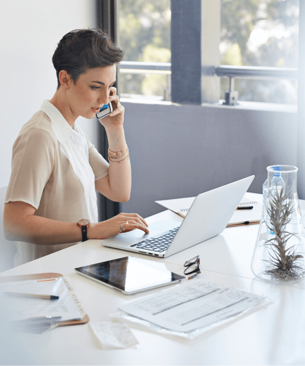 An entrepreneur using VoIP caller software to communicate with her clients.