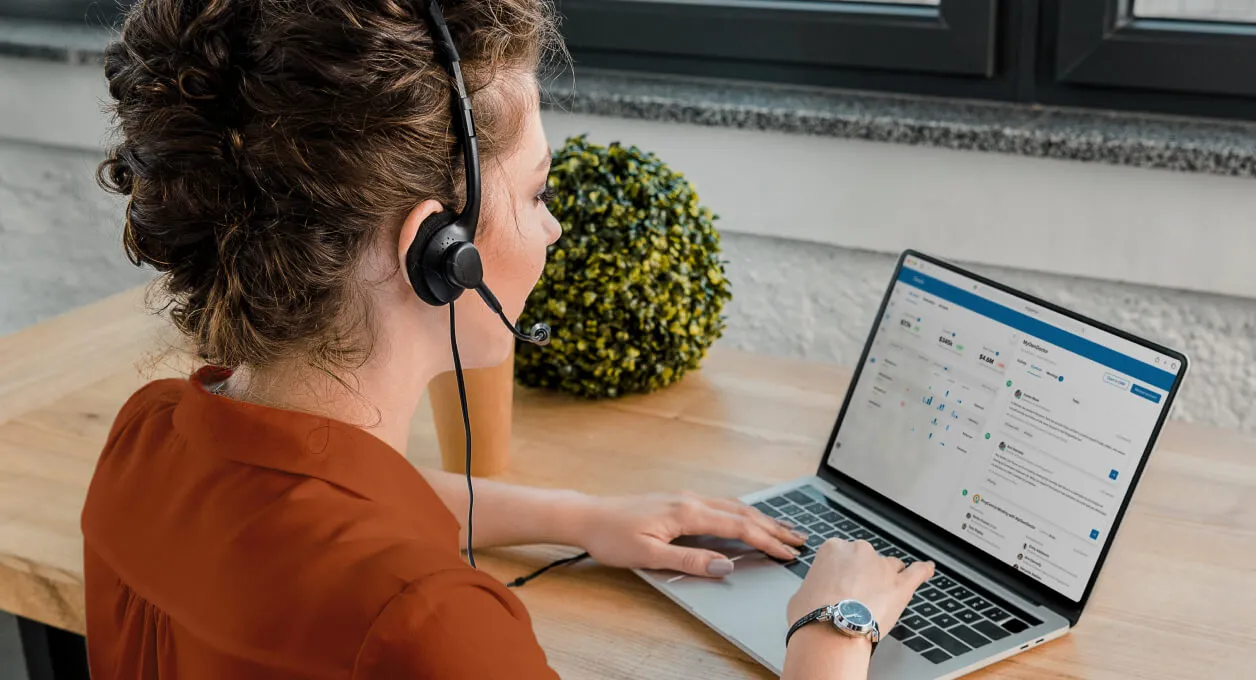 A female agent working on the RingCentral Contact Center CRM open on her laptop