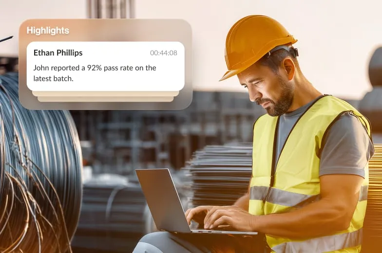 RingCentral Case Study: A manufacturing operation worker in a hard hat is typing on a laptop.