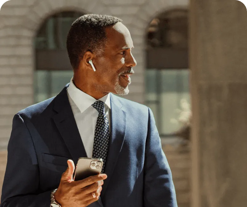 A man sending a voicemail via his mobile phone