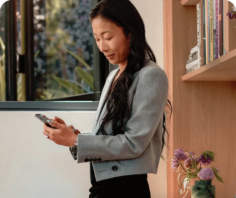 A female finance officer holding a mobile phone