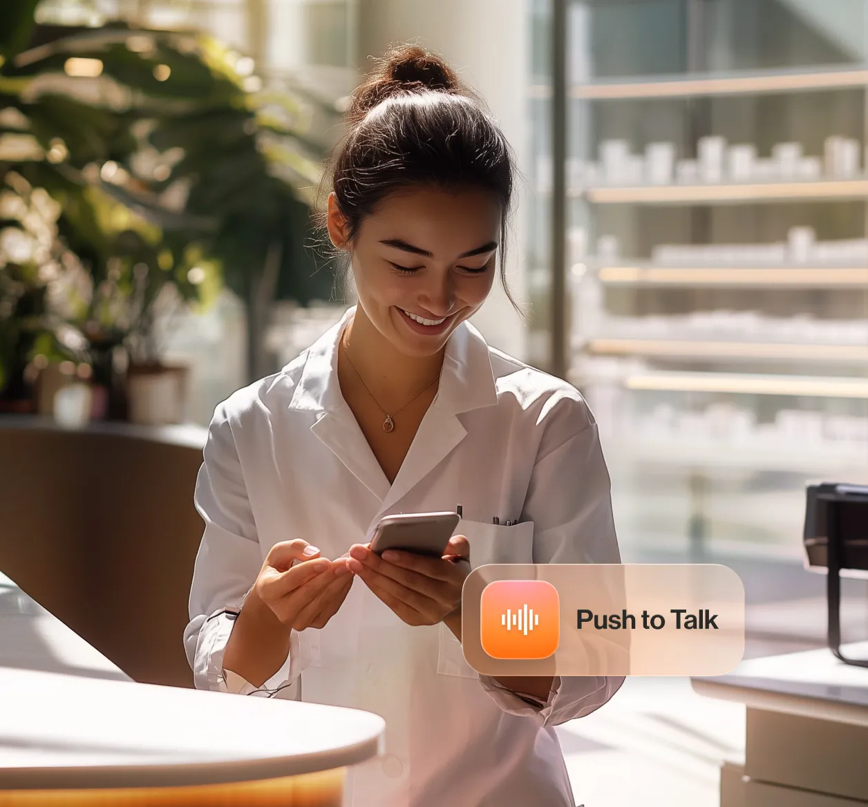 Healthcare professional using a mobile phone with RingCentral's Push to Talk feature in a bright medical office.