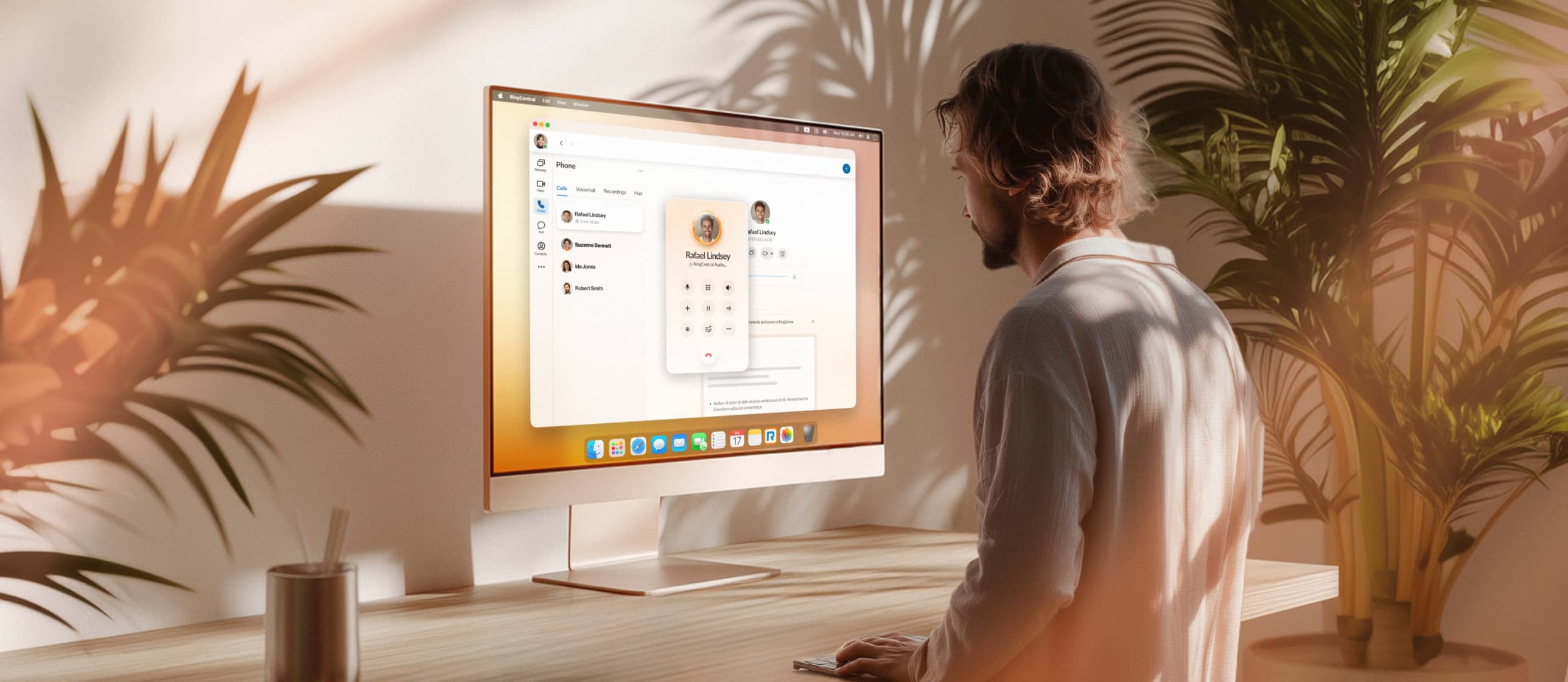 A male employee using RingCentral desktop app to make a call