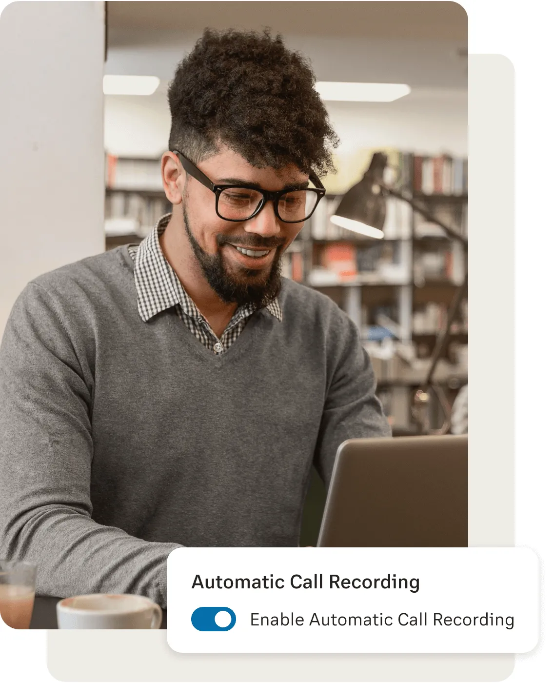 A male on laptop setting up call recording