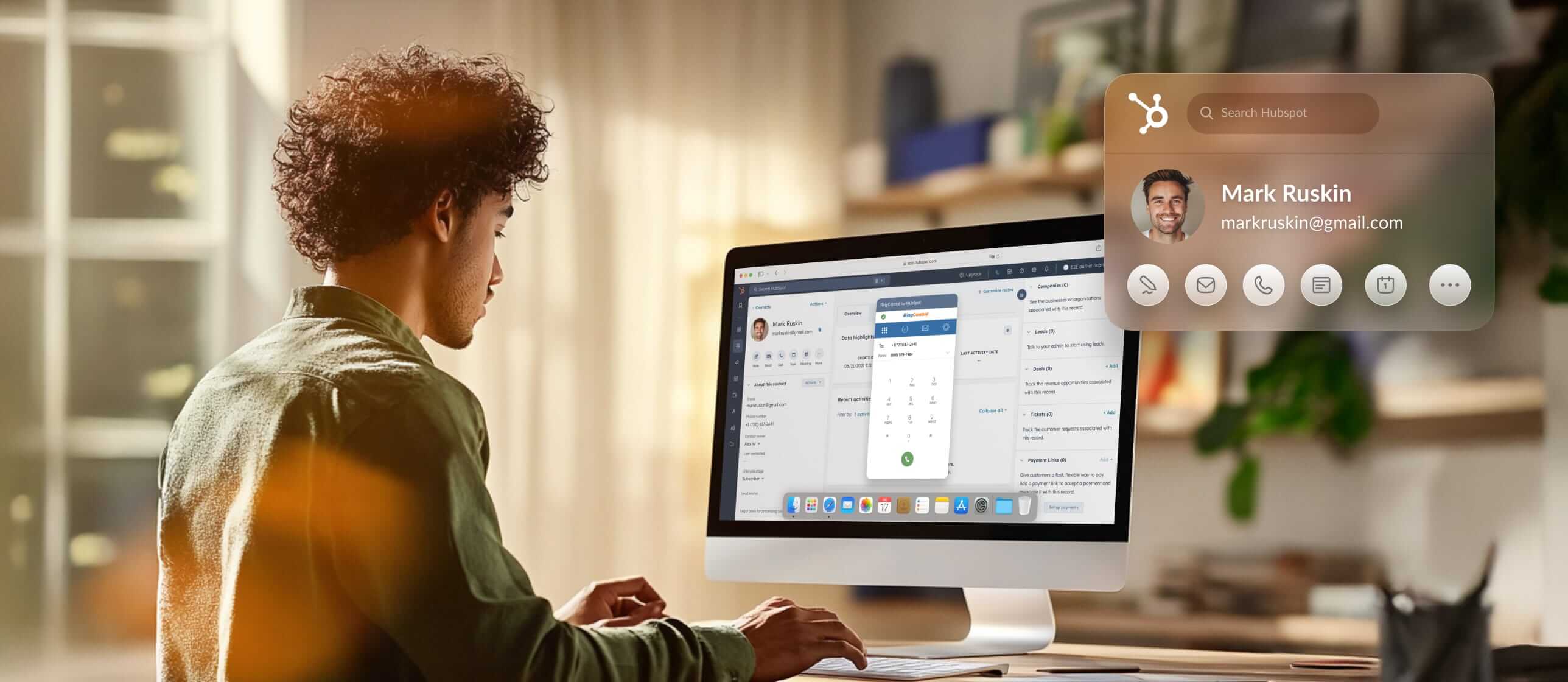 A man in forn of his computer showing the RingCentral App with inlay of a contact in Hubspot