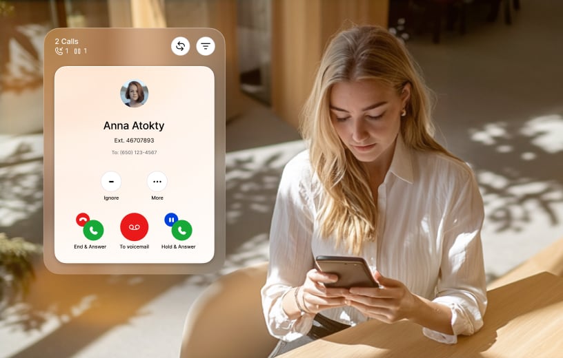 A woman on a phone call using her mobile device while working remotely from home.