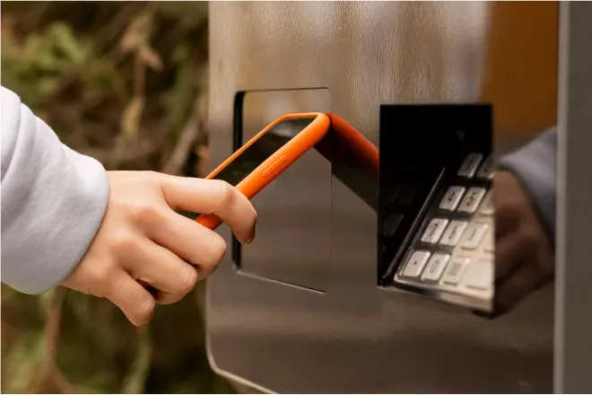 A mobile phone being tapped to an ATM