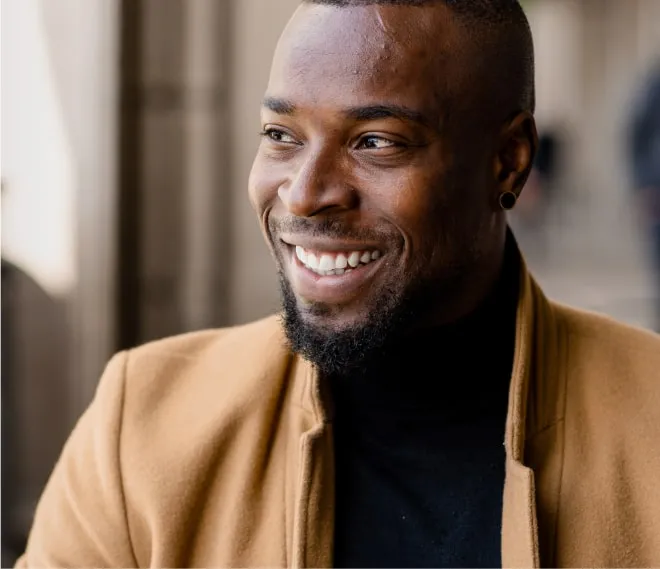 A man smiling and looking to the left