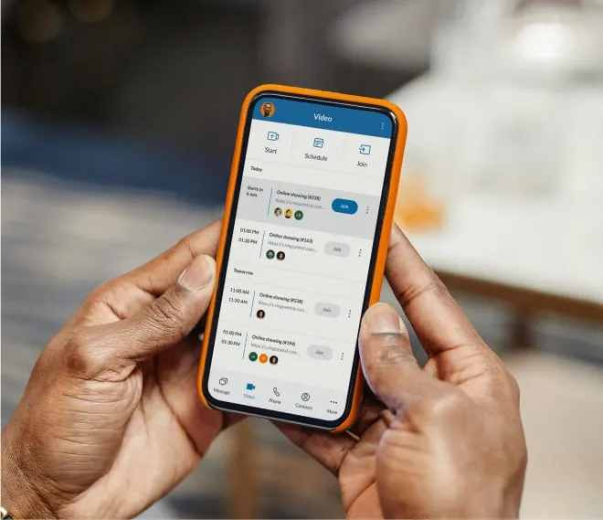 Hands holding a mobile phone while joining a RingCentral video call