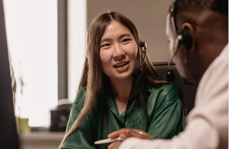 Blog cover: A female agent talking to her colleague