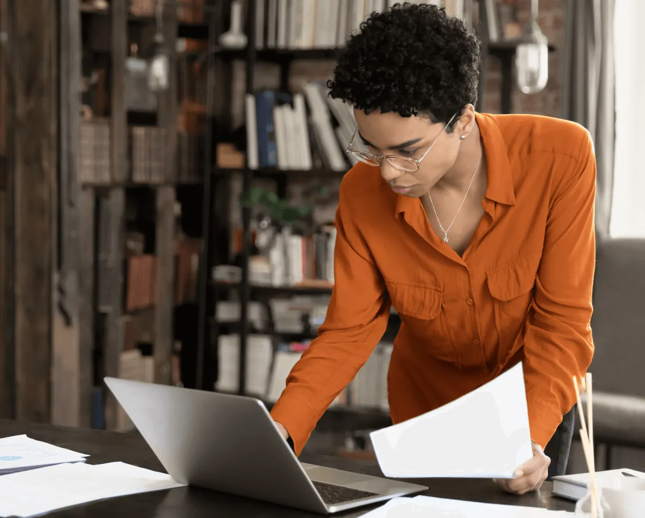 A female paralegal looks at her laptop with an insert of a list of benefits in using the RingCentral app in the legal industry
