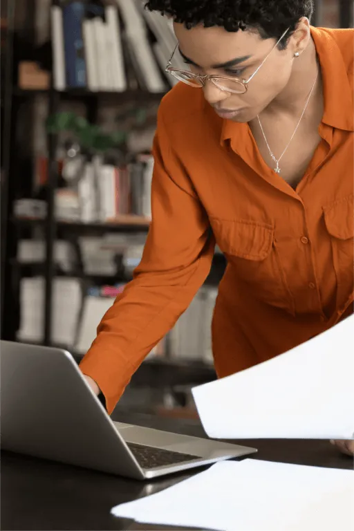 A female paralegal looks at her laptop with an insert of a list of benefits in using the RingCentral app in the legal industry