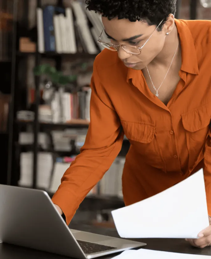 A female paralegal looks at her laptop with an insert of a list of benefits in using the RingCentral app in the legal industry
