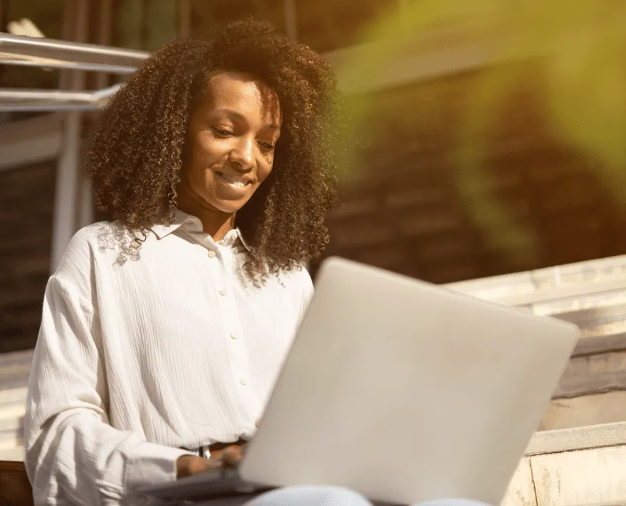 A woman working remotely on her laptop