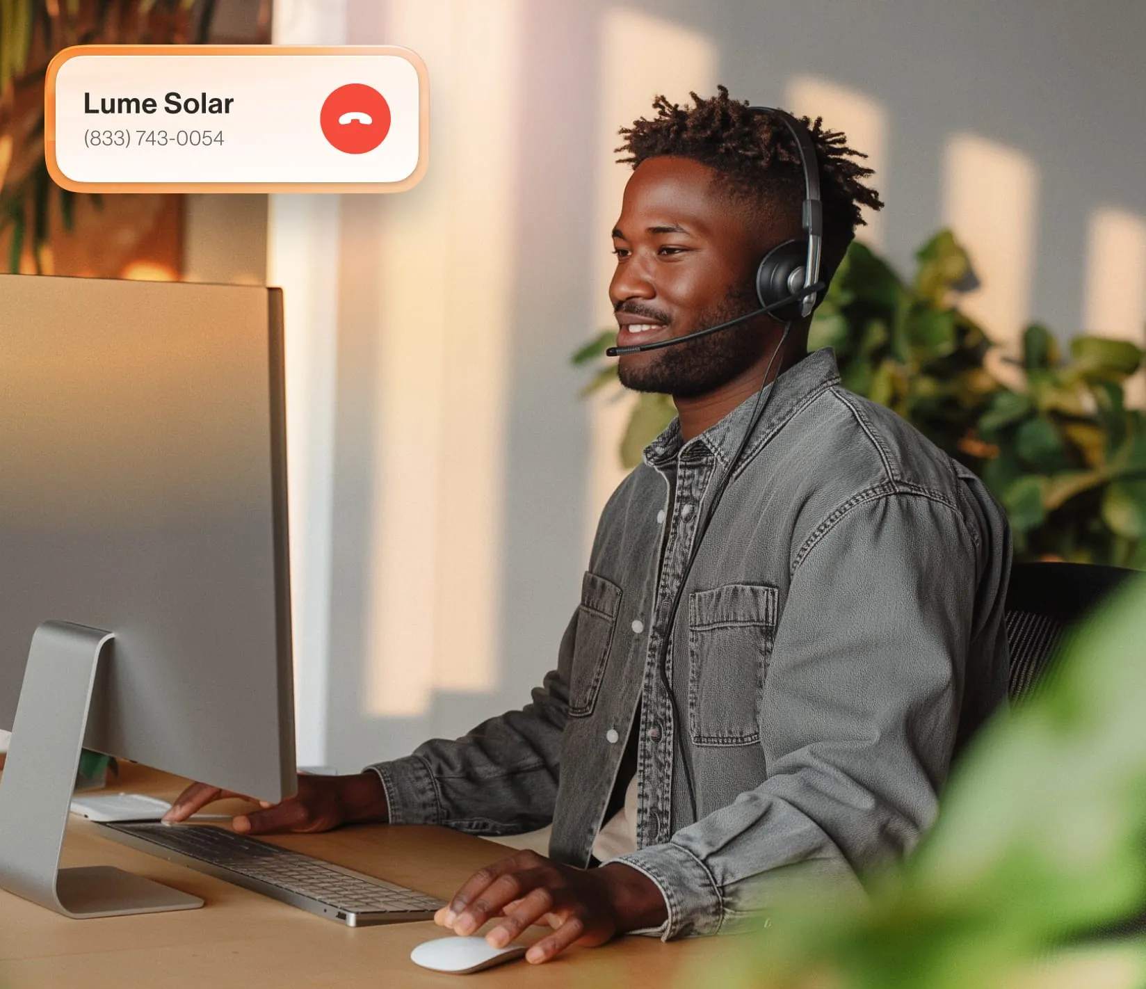 Professional using a computer and headset for a call, highlighting RingCentral's communication technology.