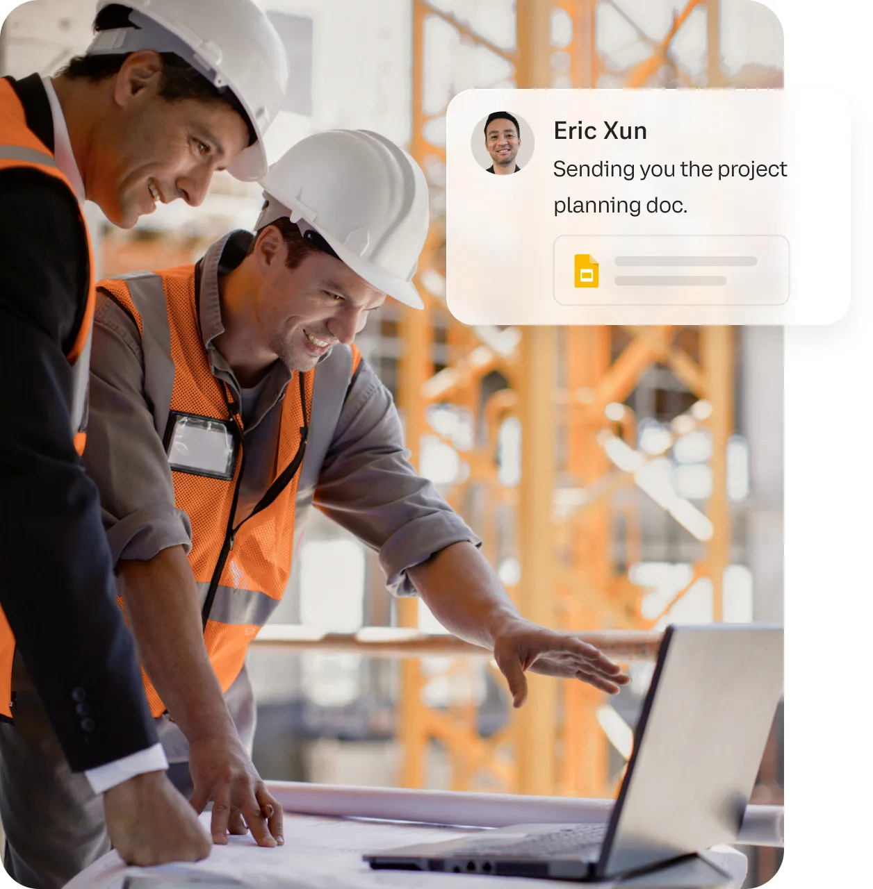 Two colleagues viewing a project planning doc sent via the RingCentral app on a laptop in a construction site