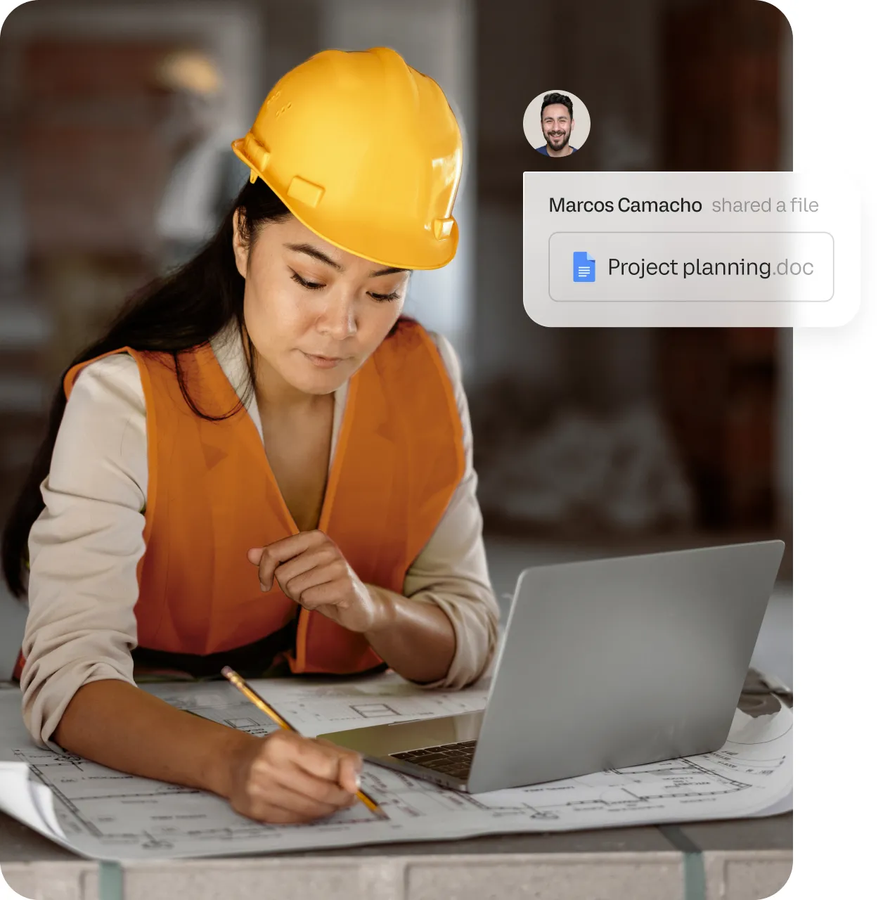 A woman viewing a construction plan received the project planning doc via the RingCentral app on her laptop