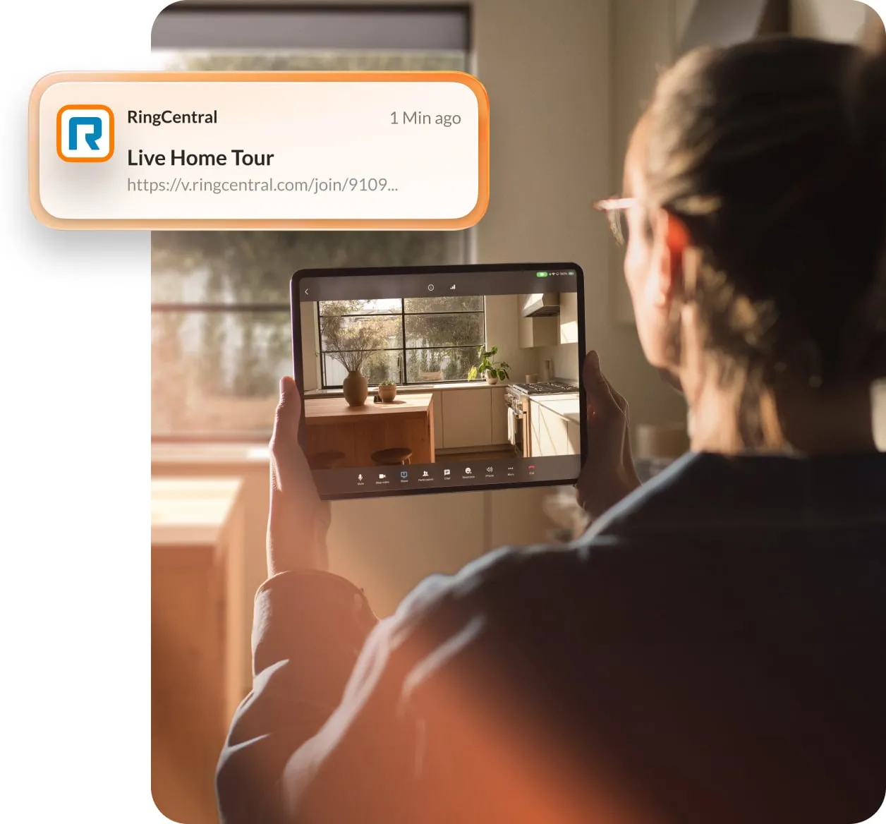 Person holding a tablet and viewing a home tour via RingCentral