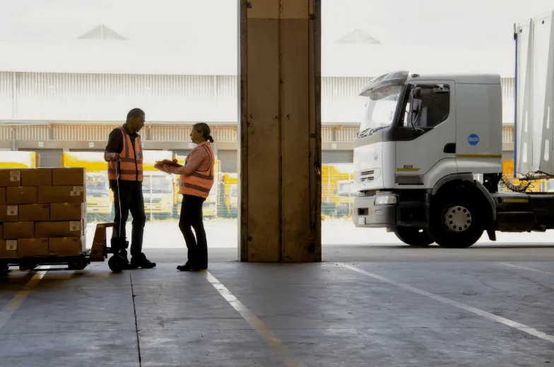 A man and a woman talking in a delivery hub