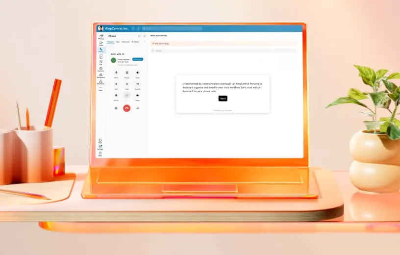 Laptop displaying RingCentral app with AI Assistant prompt on a colorful desk.